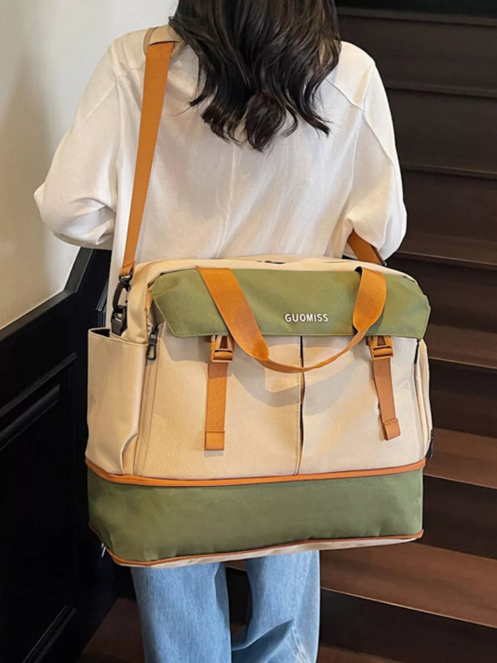 Chic nylon travel bag with olive green flap and tan straps, featuring multiple pockets and buckle details.