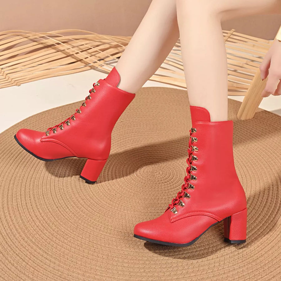 Red lace-up block heel boots with gold eyelets and a pointed toe.