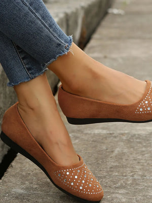 Brown suede ballet flats with rhinestone embellishments on the toe.