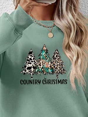 Sage green crewneck sweatshirt with country Christmas graphic trees in cow print, leopard print, and abstract patterns.