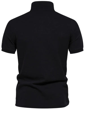 Black piqué polo shirt with short sleeves and embroidered detail on the left sleeve.