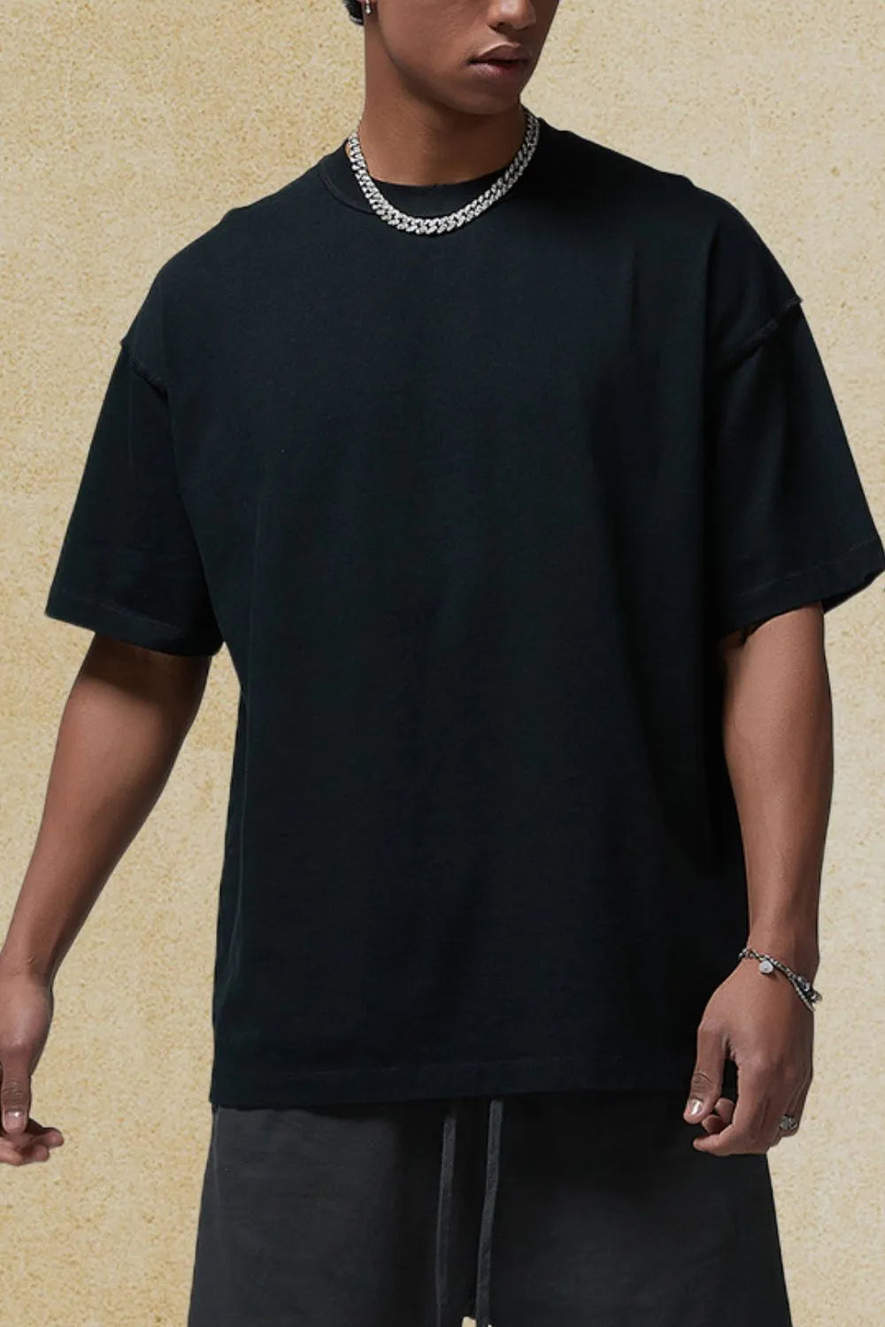 Black half sleeve t-shirt with raw hem detail and crew neck.