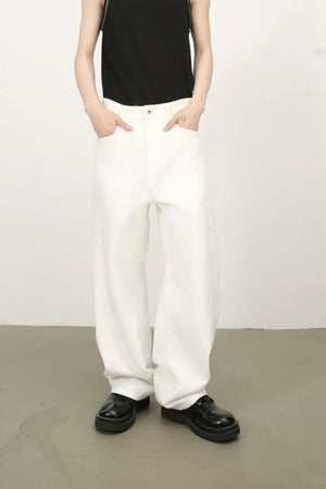White wide leg trousers with sculpted pocket details and a relaxed fit.