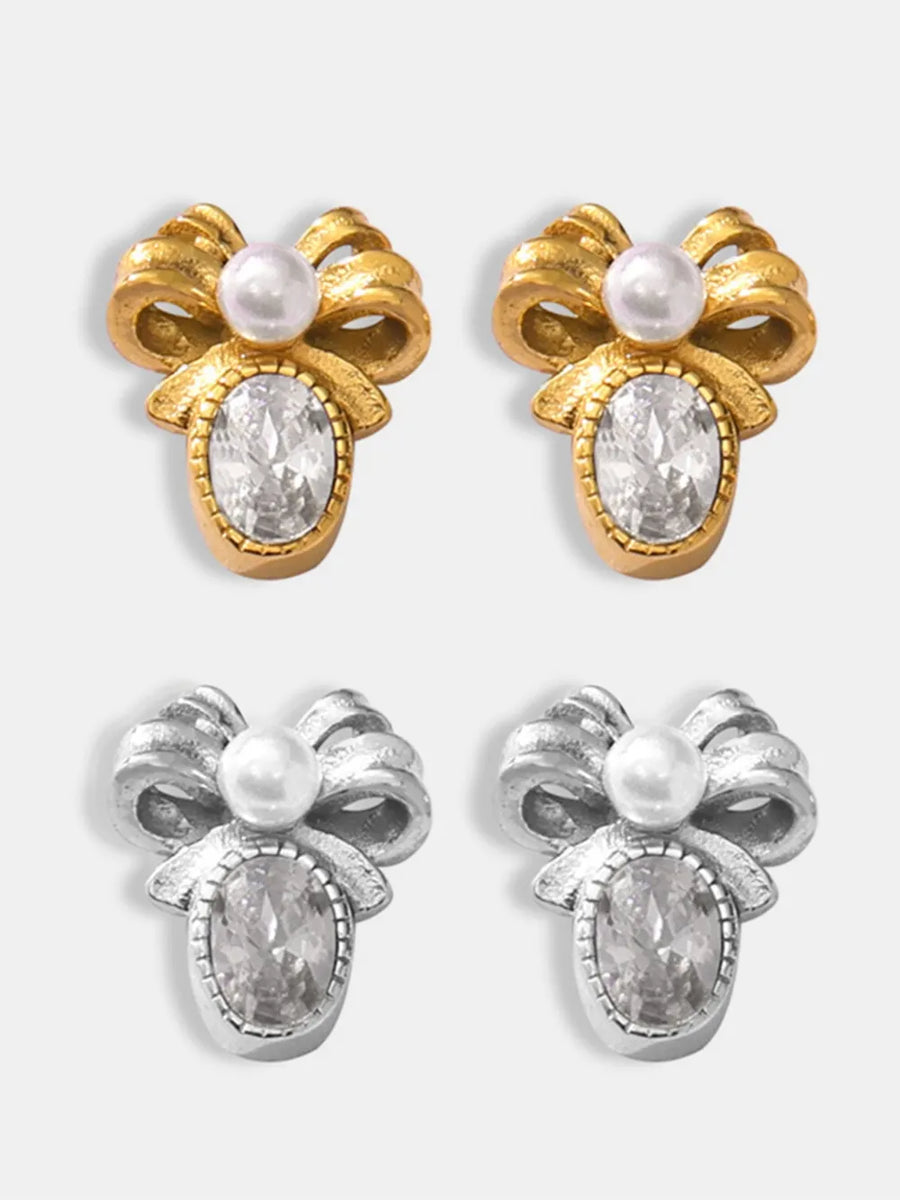 Gold and silver bow stud earrings with pearl and oval crystal details
