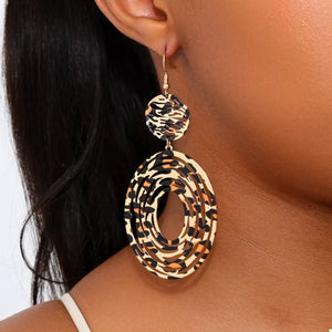 Bold dangle earrings in 18K gold with leopard print pattern.