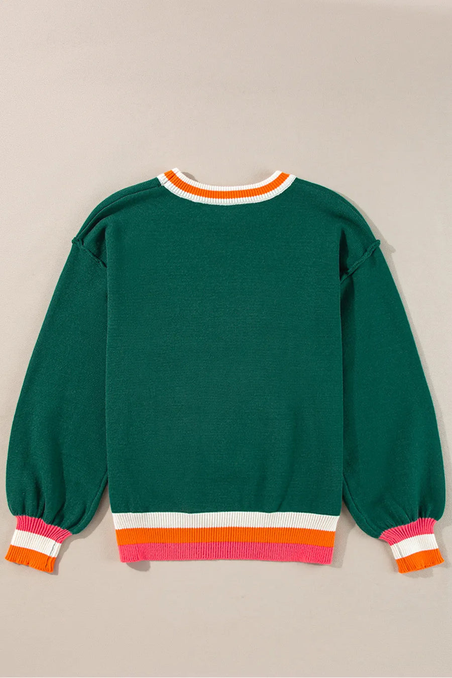 Dark green knit sweater with balloon sleeves and colorblock trim at neckline and hem.