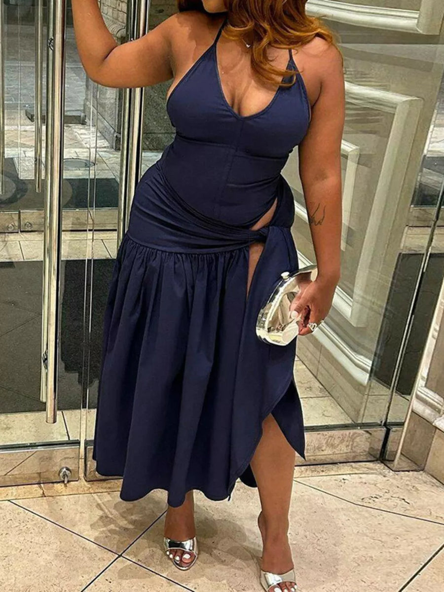 Navy blue halter neck ruched maxi dress with deep v-neck and thigh-high slit