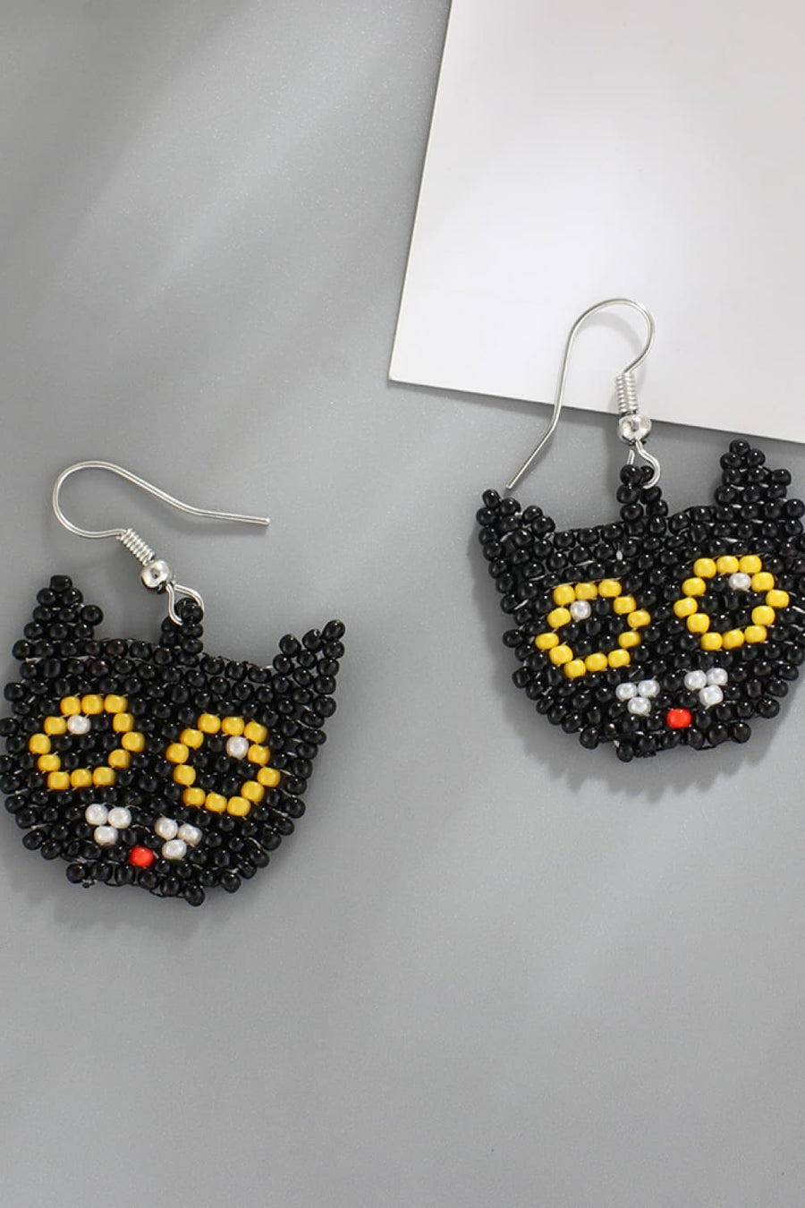 Black cat beaded earrings with yellow eyes and red nose.