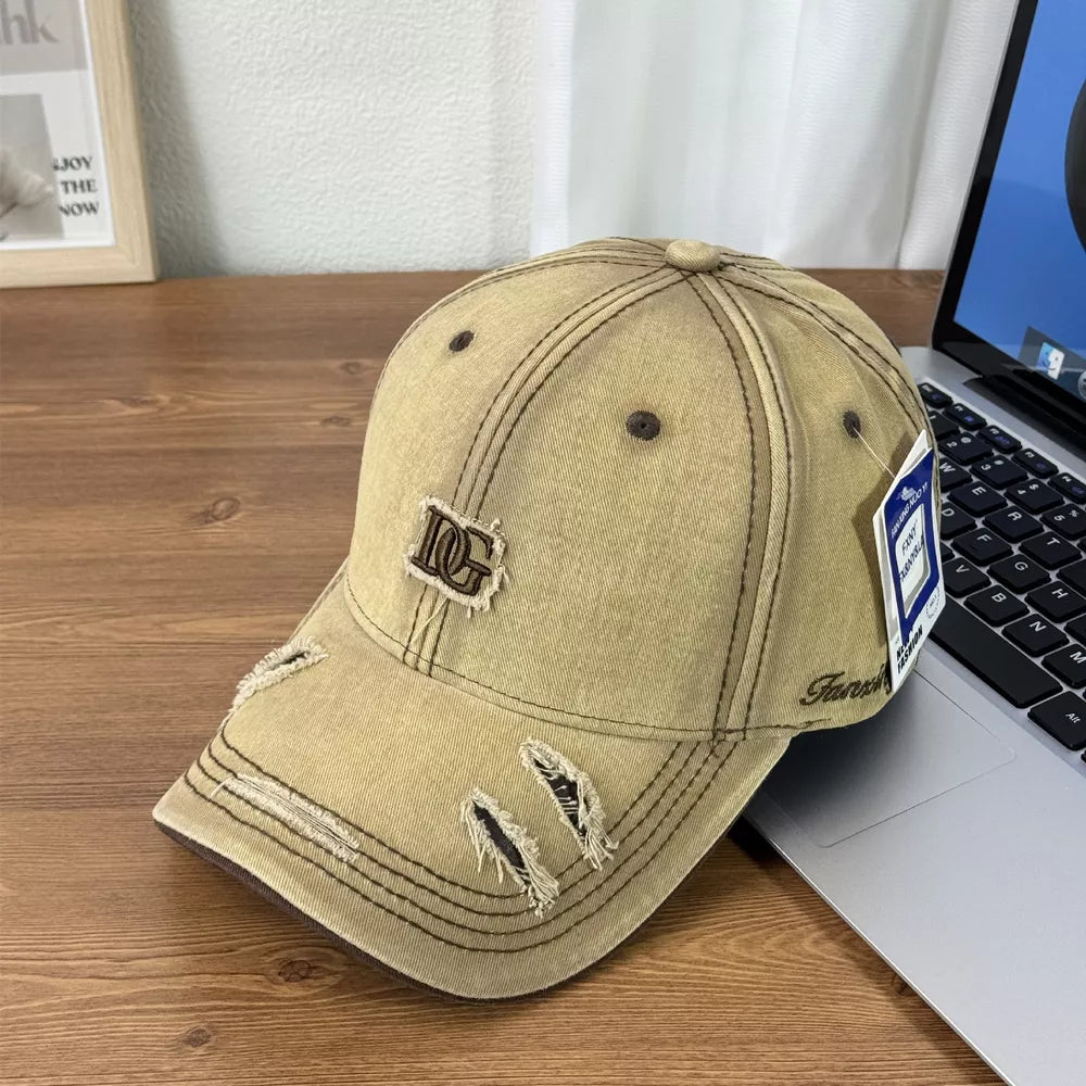 Distressed tan baseball cap with DG logo patch and ripped details.