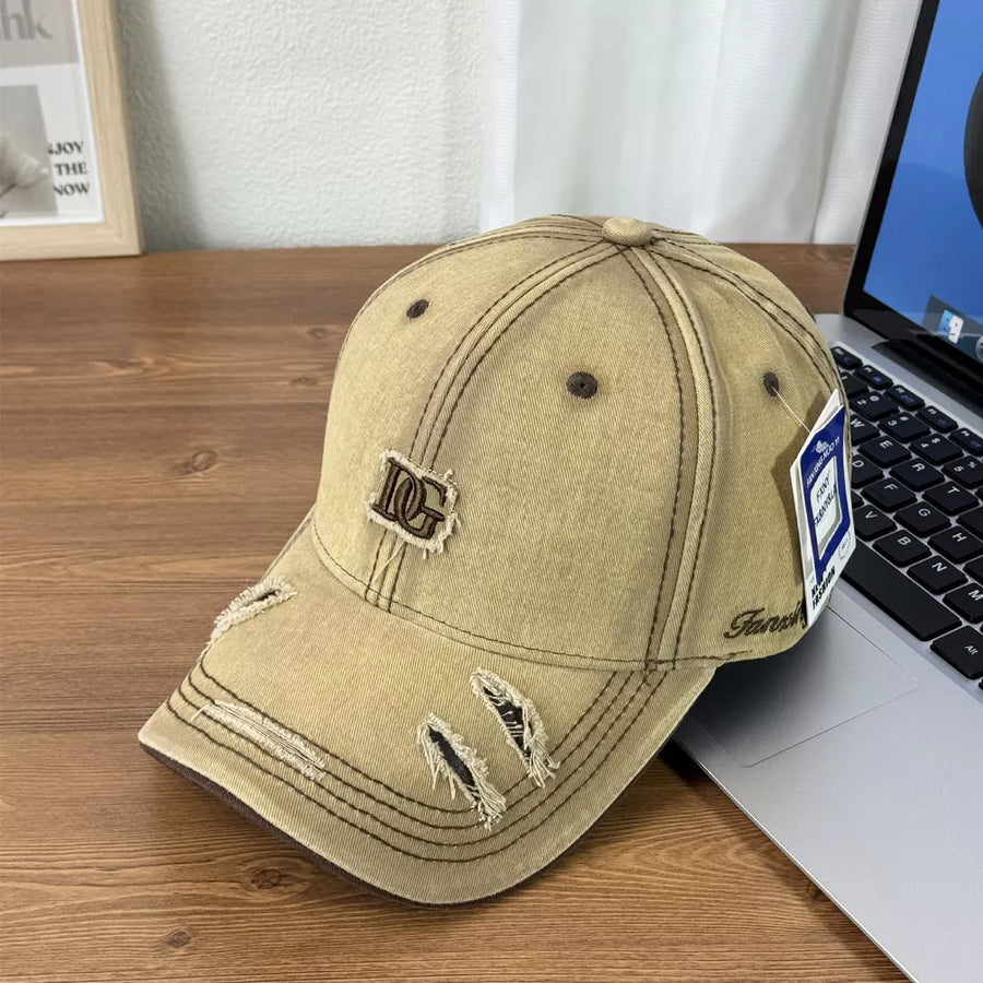 Distressed tan baseball cap with DG logo patch and ripped details.