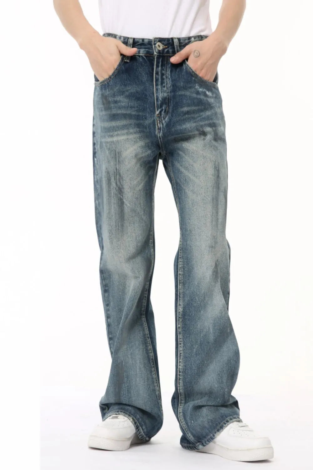 Baggy distressed denim flare jeans in medium wash with a comfortable fit.