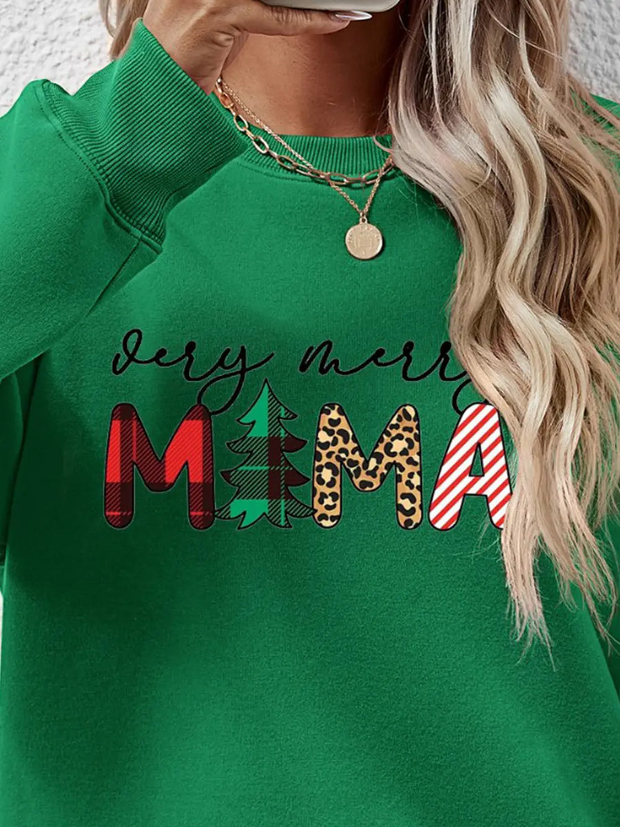Green long sleeve sweater with abstract Christmas graphic print and text.