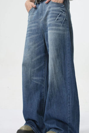 Oversized denim palazzo trousers in medium wash with a relaxed fit and wide leg.