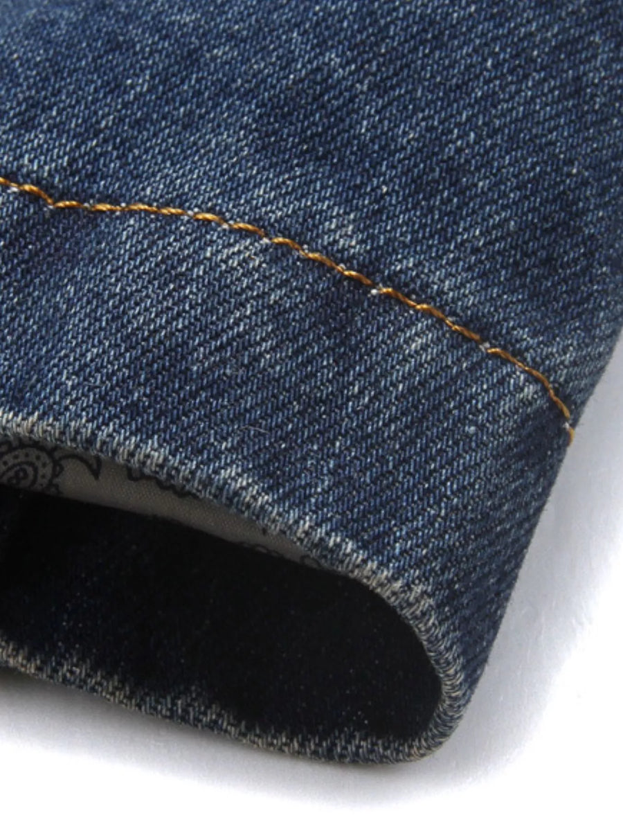 Men's denim blazer in blue with contrast stitching and patterned lining detail.