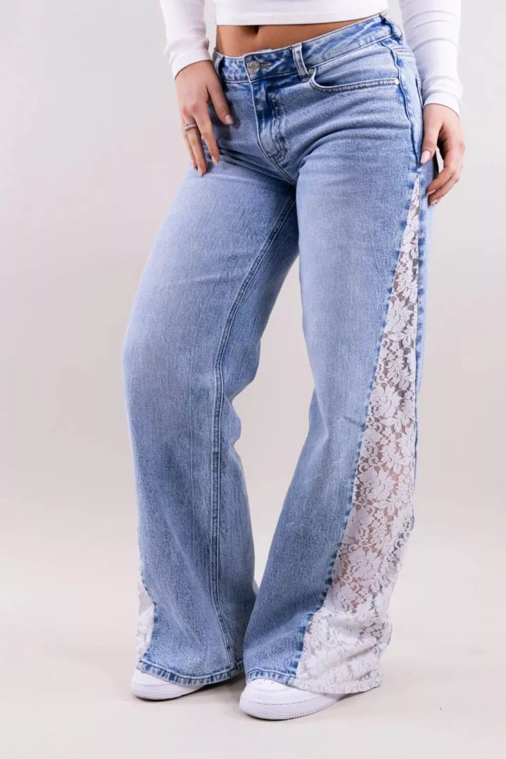 wide-leg jeans in light blue featuring lace detail and flared fit