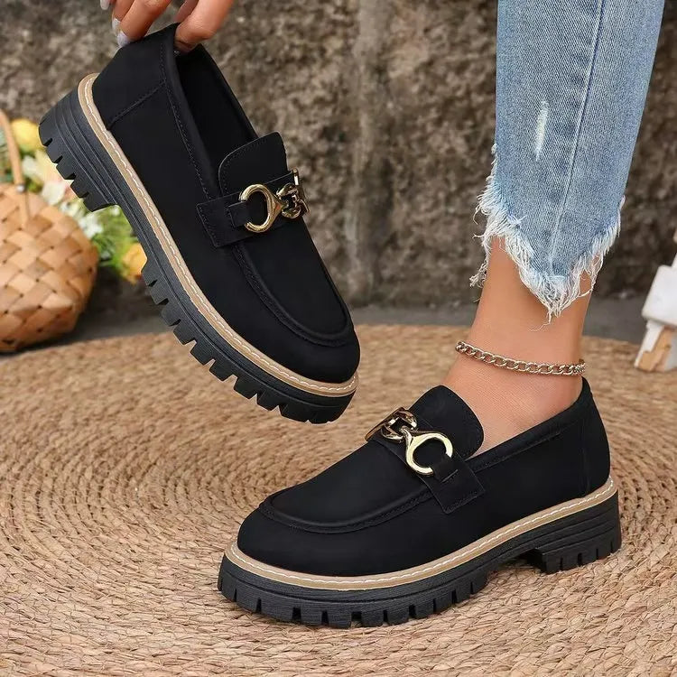 Black chunky chain detail platform loafers with lug sole and tan trim.