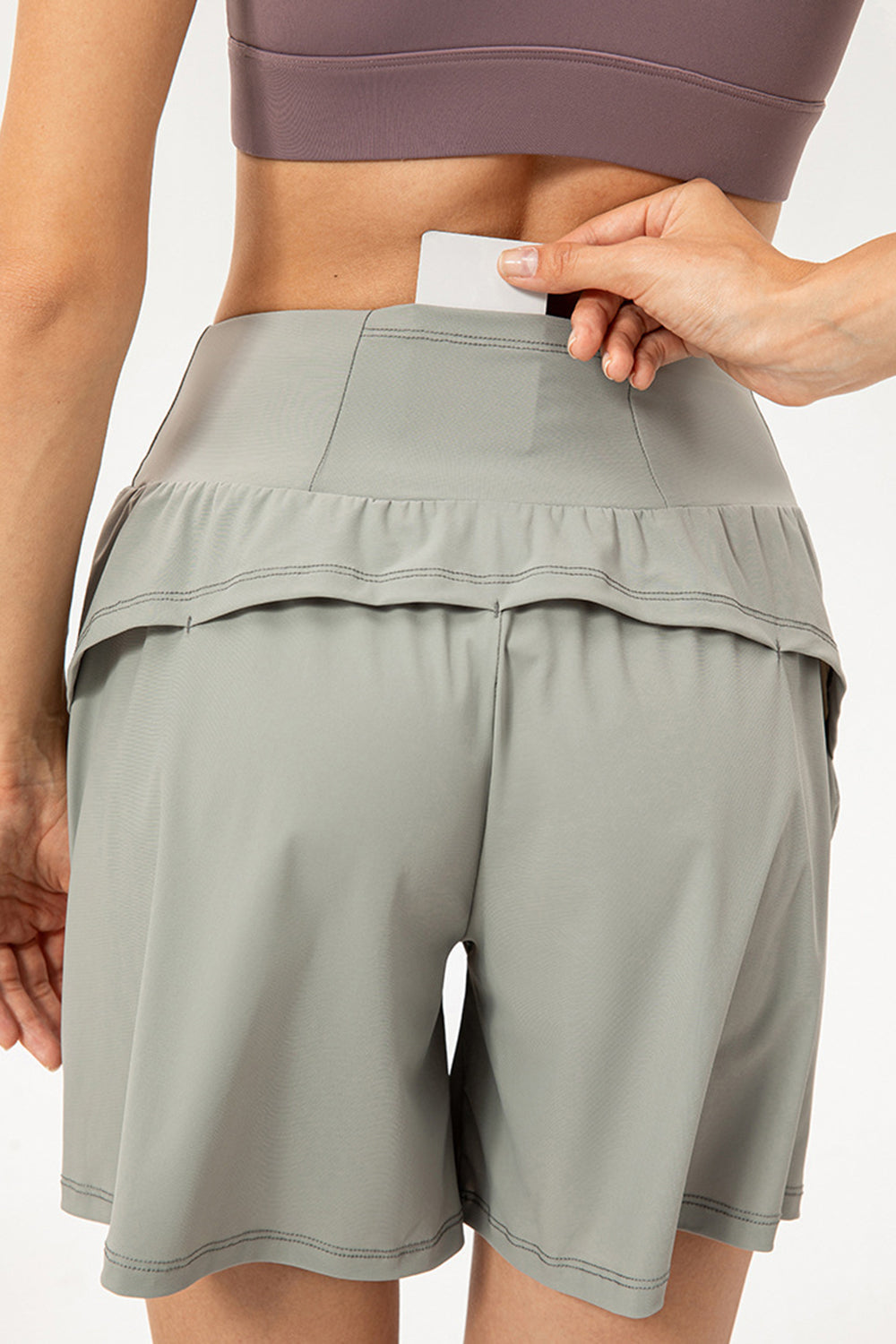 Active layered pocket shorts in sage with a hidden waistband pocket for cards.