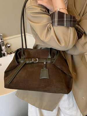 Women's chic brown suede shoulder bag with green trim and buckle detail