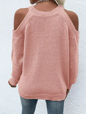 Pink cold shoulder knit sweater with crew neck and long sleeves.