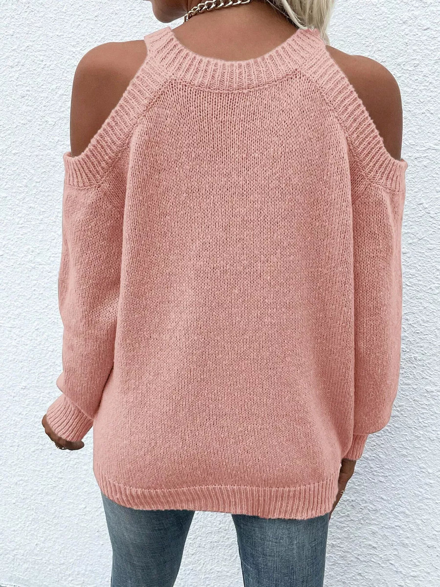 Pink cold shoulder knit sweater with crew neck and long sleeves.