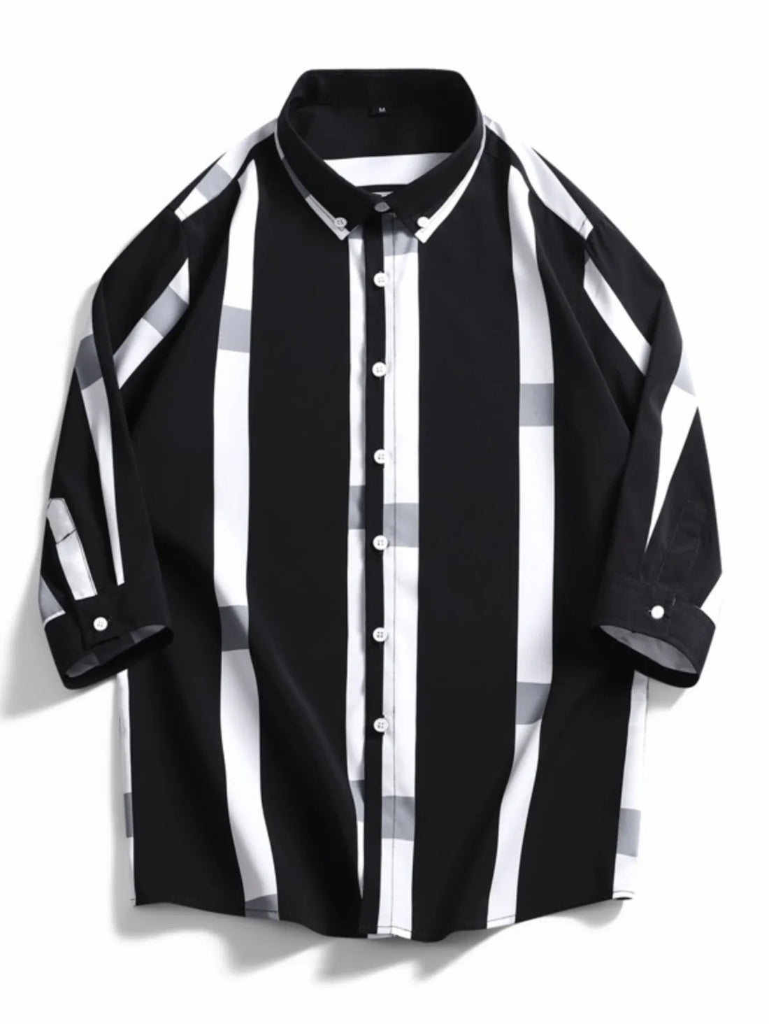 Oversized button-up shirt in black with white and grey stripes and plaid accents.