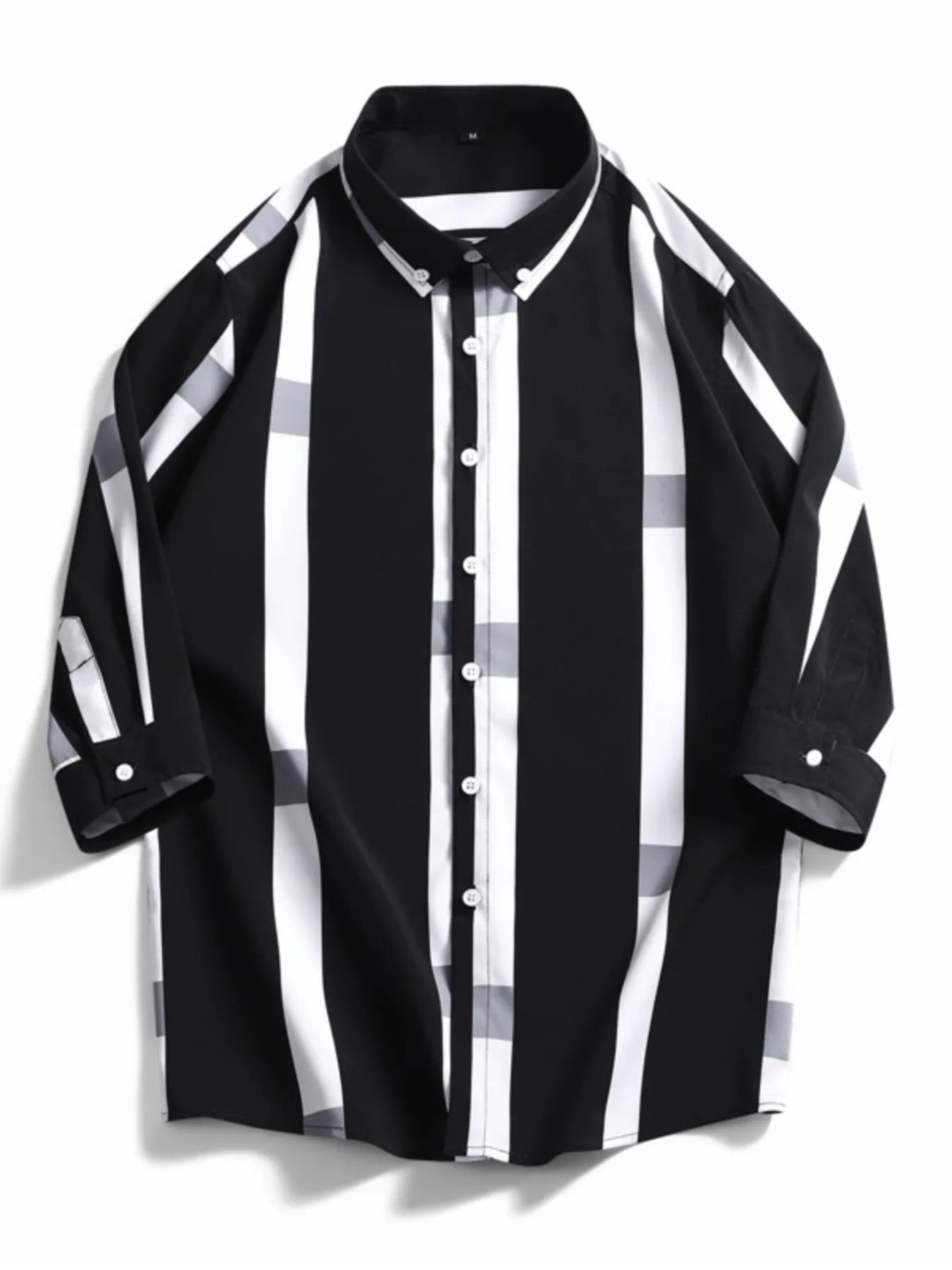 Oversized button-up shirt in black with white and grey stripes and plaid accents.