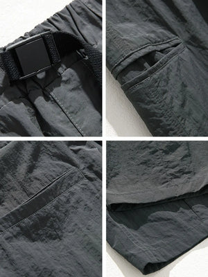 Dark gray technical fabric cargo pants with belt detail, cargo pockets, and stitching.