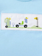 Light blue cotton tee with embroidered golf cart, golf bag, and giraffe flag detail.
