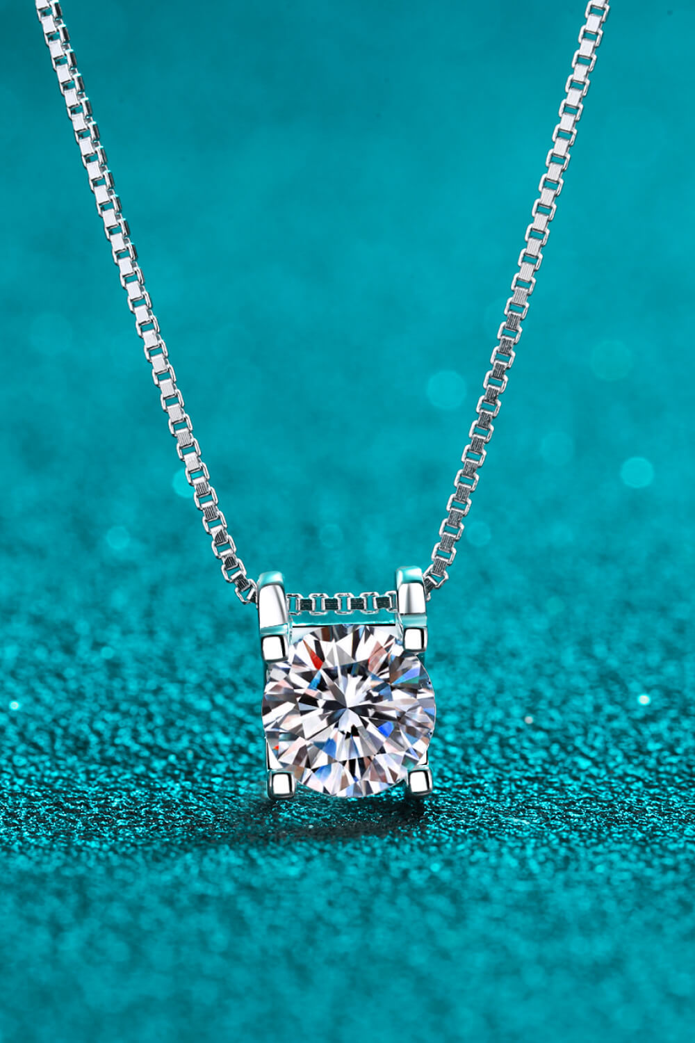 Sterling silver solitaire moissanite pendant necklace with a box chain.