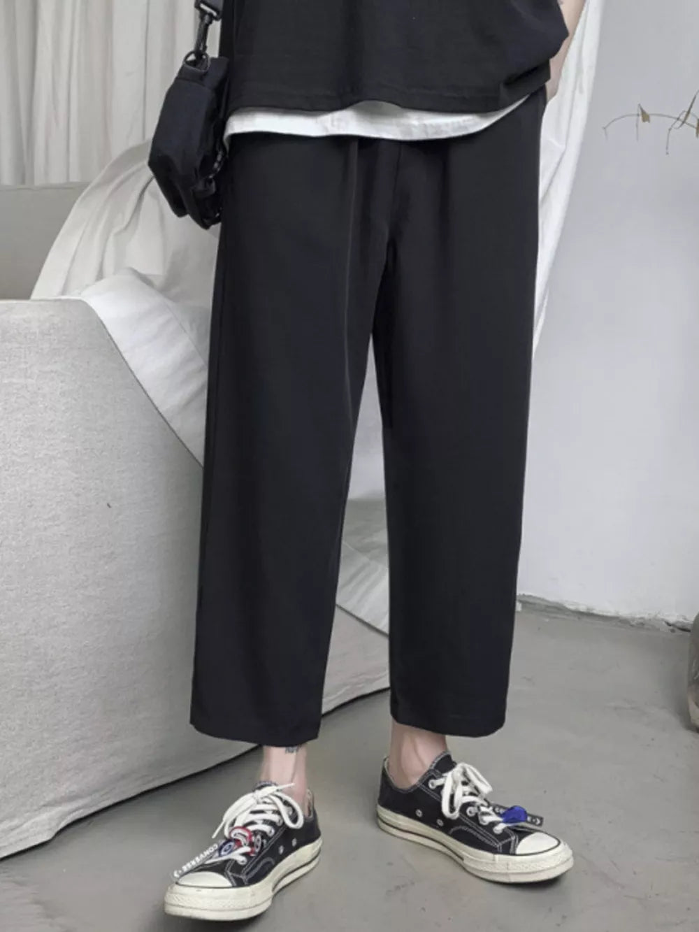 Black relaxed fit cropped sweatpants with drawstring waist and wide leg.