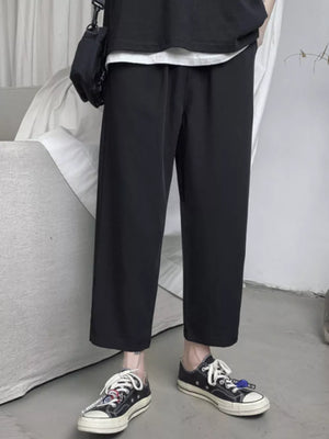 Black relaxed fit cropped sweatpants with drawstring waist and wide leg.