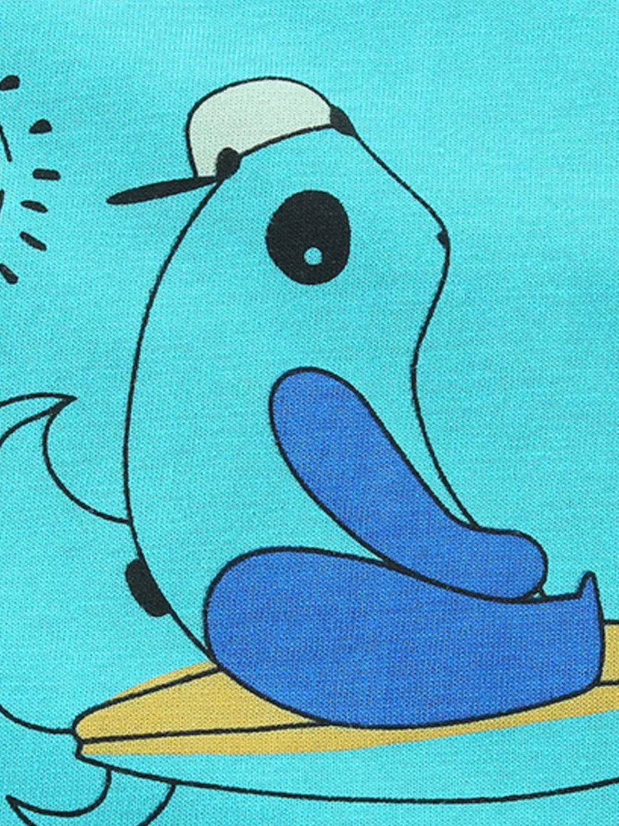 Aqua t-shirt with playful cartoon character wearing a hat and sitting on a surfboard.