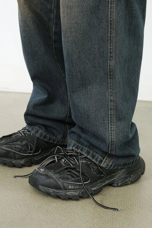 Dark wash wide-leg cargo jeans with visible stitching detail.
