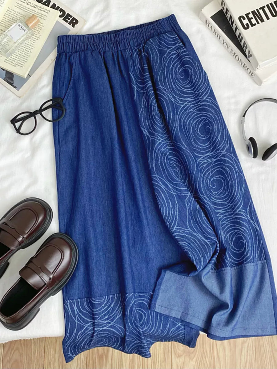 Blue denim jeans with drawstring waist and rose print detail.