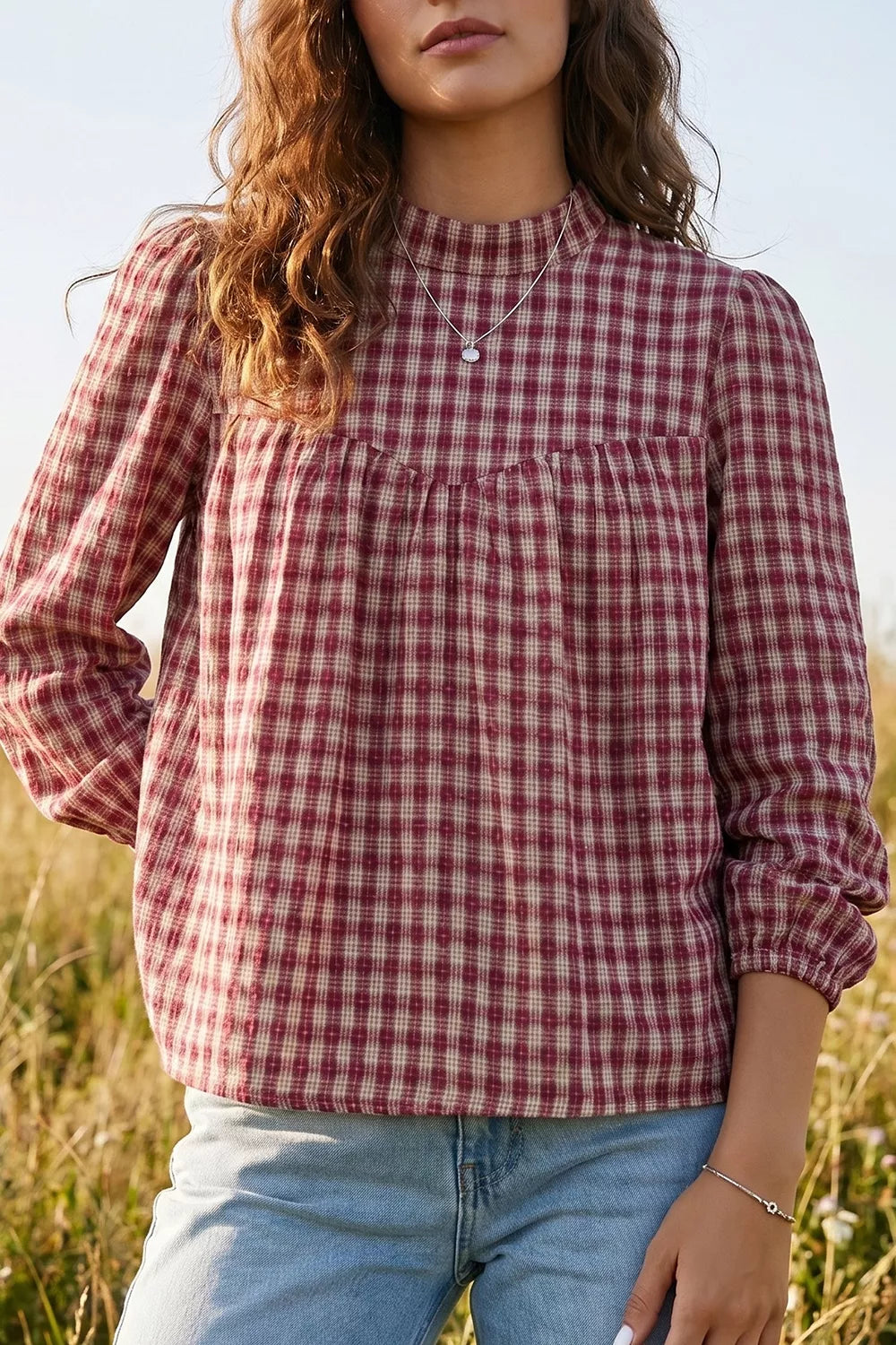 Burgundy plaid long sleeve blouse with button keyhole detail and gathered neckline.