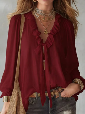 Burgundy frilled tie-front shirt with long sleeves and ruffled neckline.