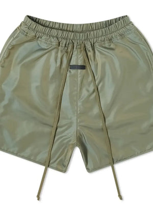 Matcha green nylon drawstring shorts with curved hem detail and elastic waistband.