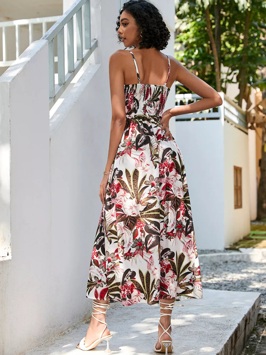 Chic floral midi dress with spaghetti straps and smocked bodice, white with red and green tropical print.