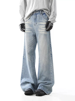 Men's light wash wide-leg jeans with distressed details and button closure.