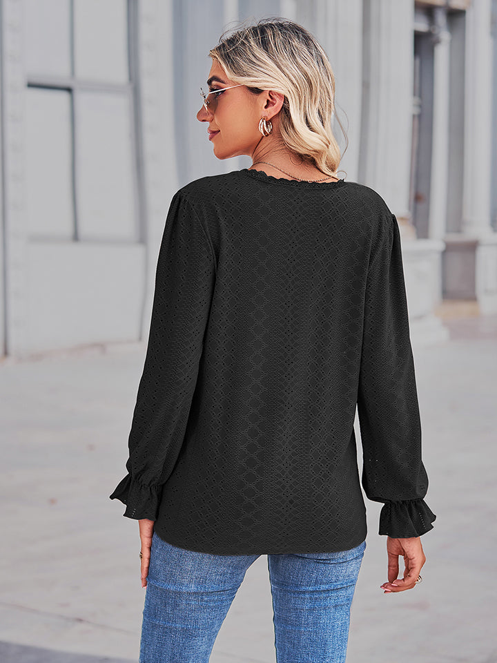 Black lace trim eyelet blouse with ruffle cuffs and long sleeves.