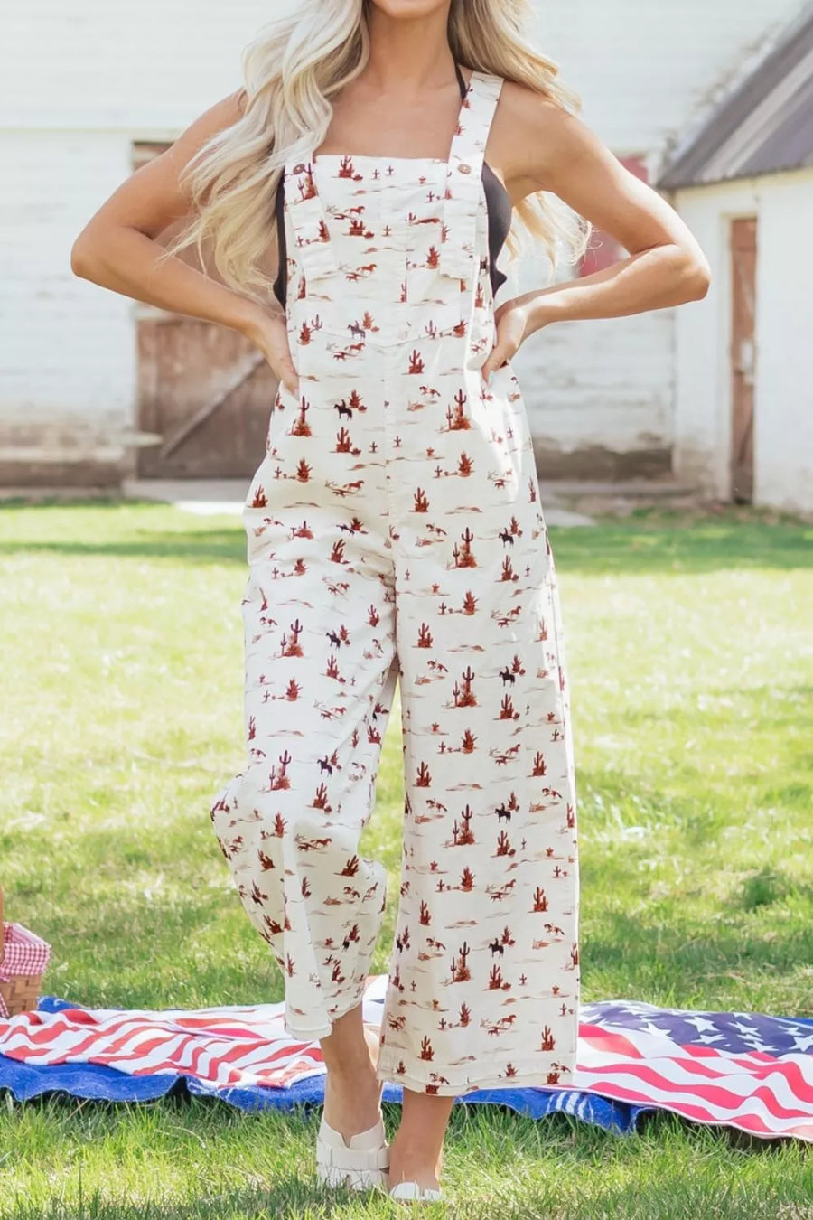 Desert motif adjustable jumpsuit in beige cotton with cropped wide legs and a desert landscape pattern.