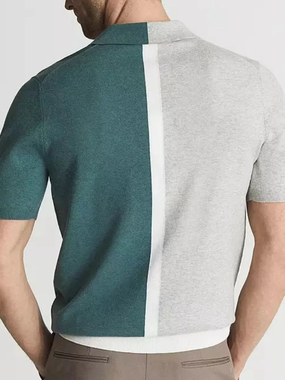 Colorblock polo shirt in dark green and grey with a white contrast stripe down the back.