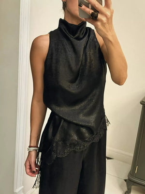Black asymmetrical cami top with lace trim and mock neck.