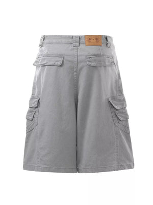 Grey cargo capris for men with multiple pockets and a leather brand patch.
