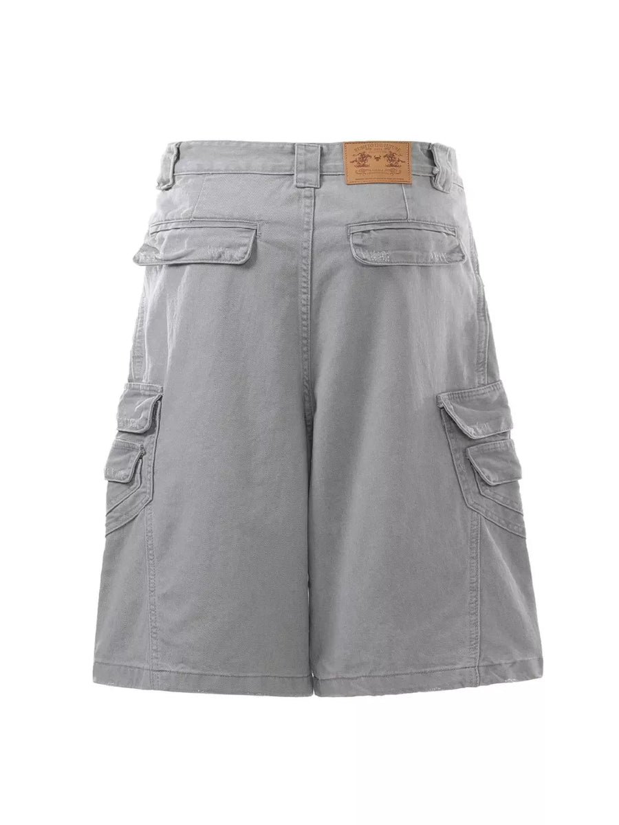 Grey cargo capris for men with multiple pockets and a leather brand patch.