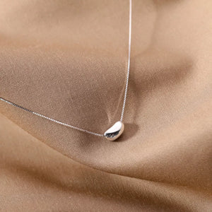 Sterling silver bean pendant necklace with a delicate box chain.