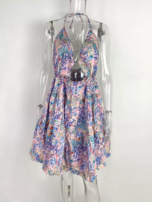 Dusty Pink halter mini dress with abstract floral print, cutout detail, and ruffled hem.