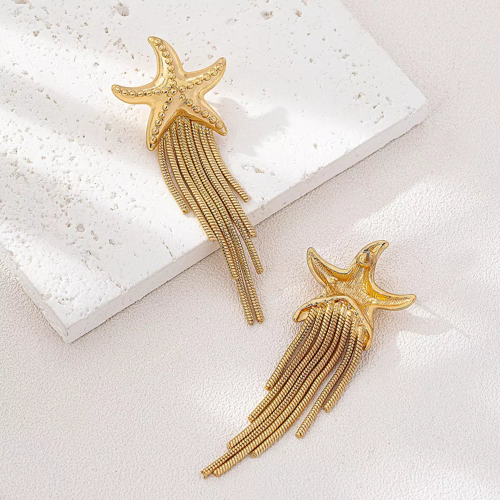 Gold earrings featuring fringe and motif