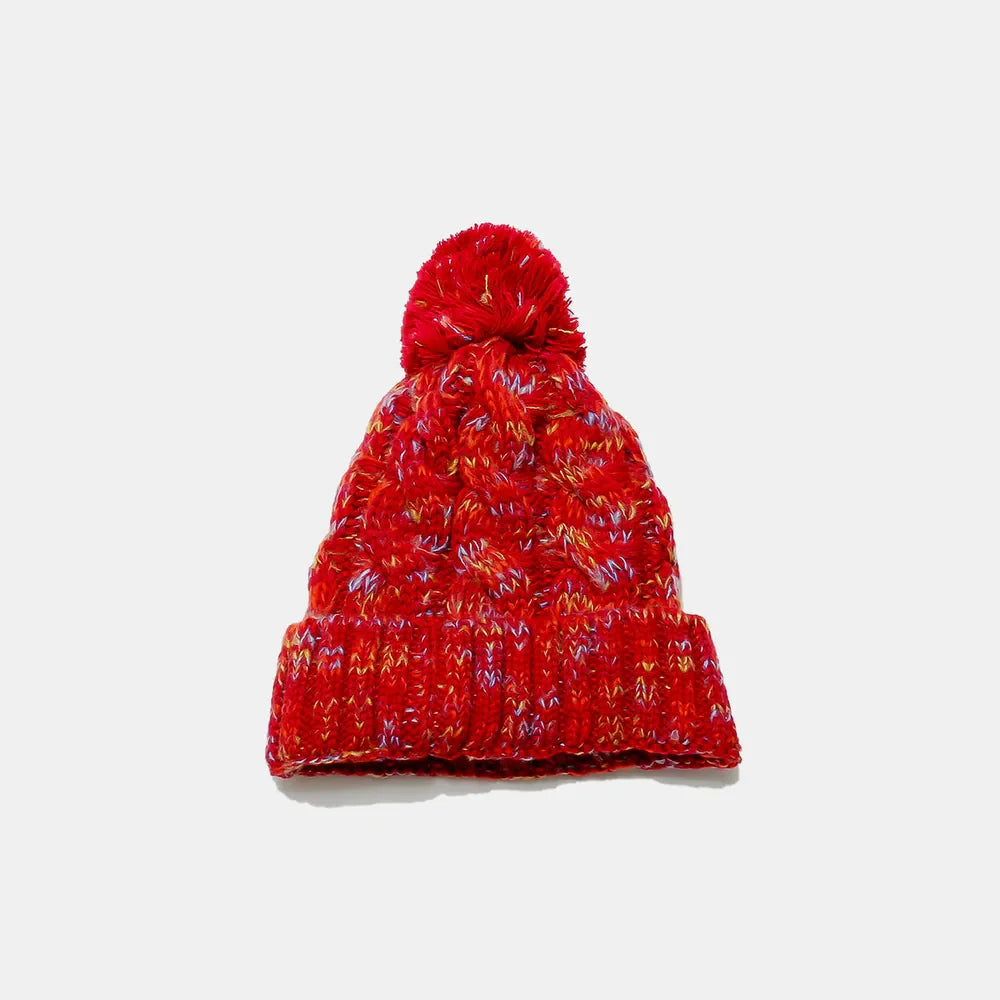 Textured knit pom beanie in Deep Red with multicolor flecks and cable knit pattern.