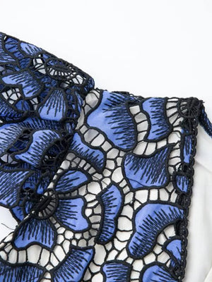Blue floral lace midi dress with V-neck and black trim detail.